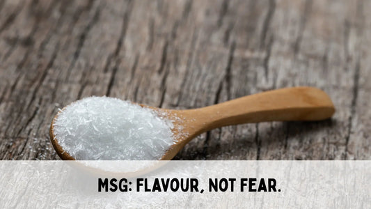 wooden background with a wooden spoon of monosodium glutamate